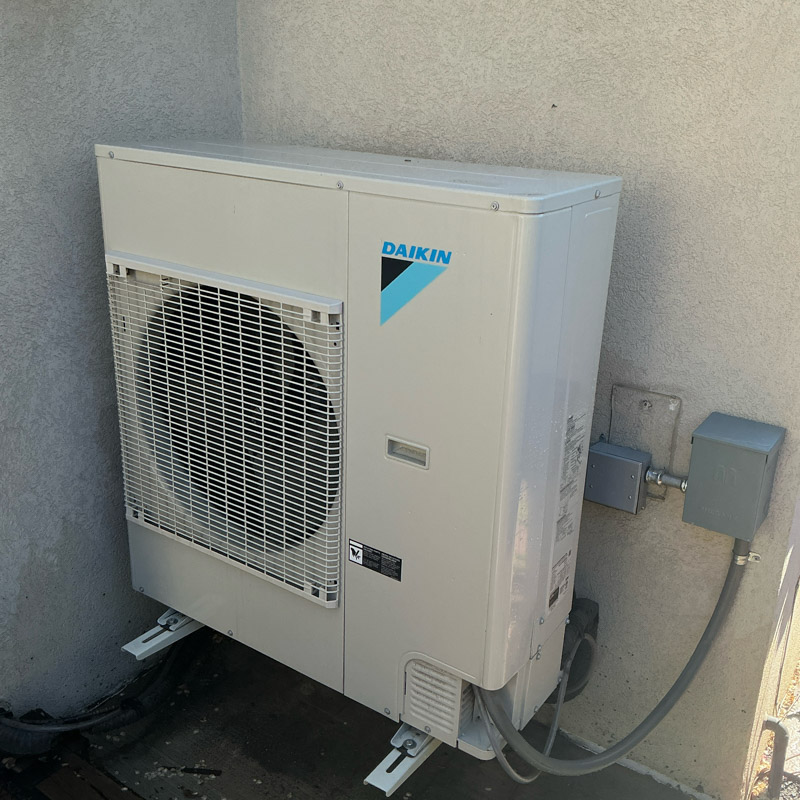 Daikin outdoor heat pump installed beside a Colorado home