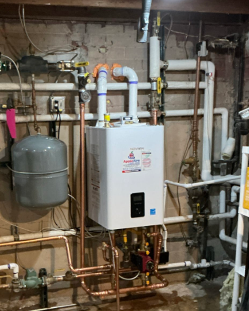 Wall-mounted Navien boiler and hydronic heating equipment installed by Apple Aire in a Colorado home