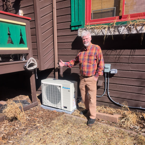 Customer with his thumb up standing next to a recently installed daikin heating and cooling unit in Evergreen Colorado